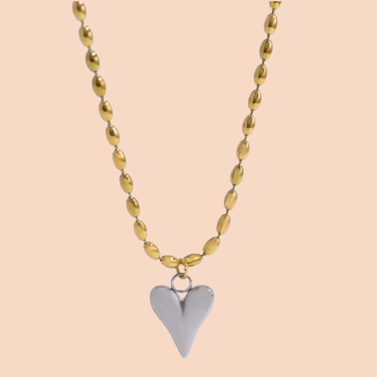 Necklace with a heart pendant on a peach background