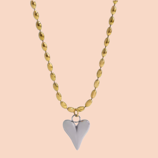 Necklace with a heart pendant on a peach background