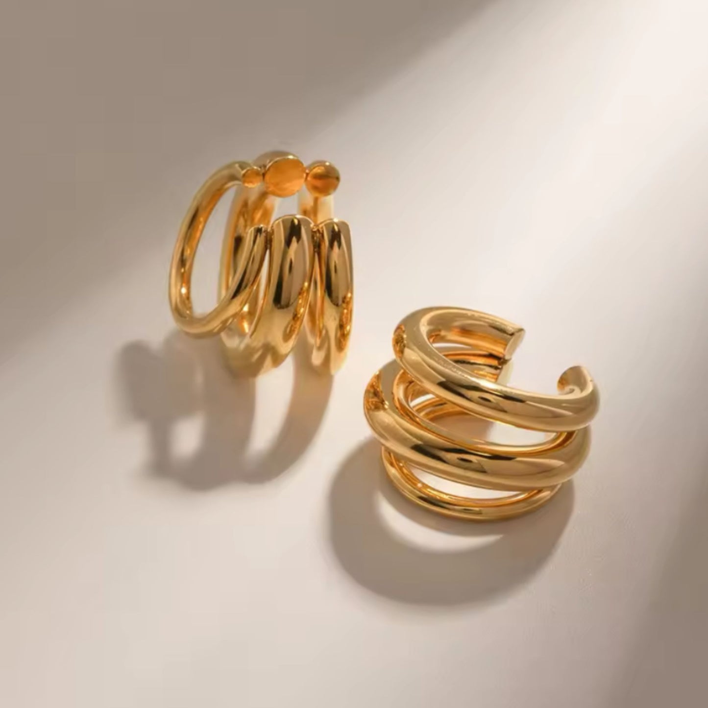 Pair of gold hoop earrings on a light background