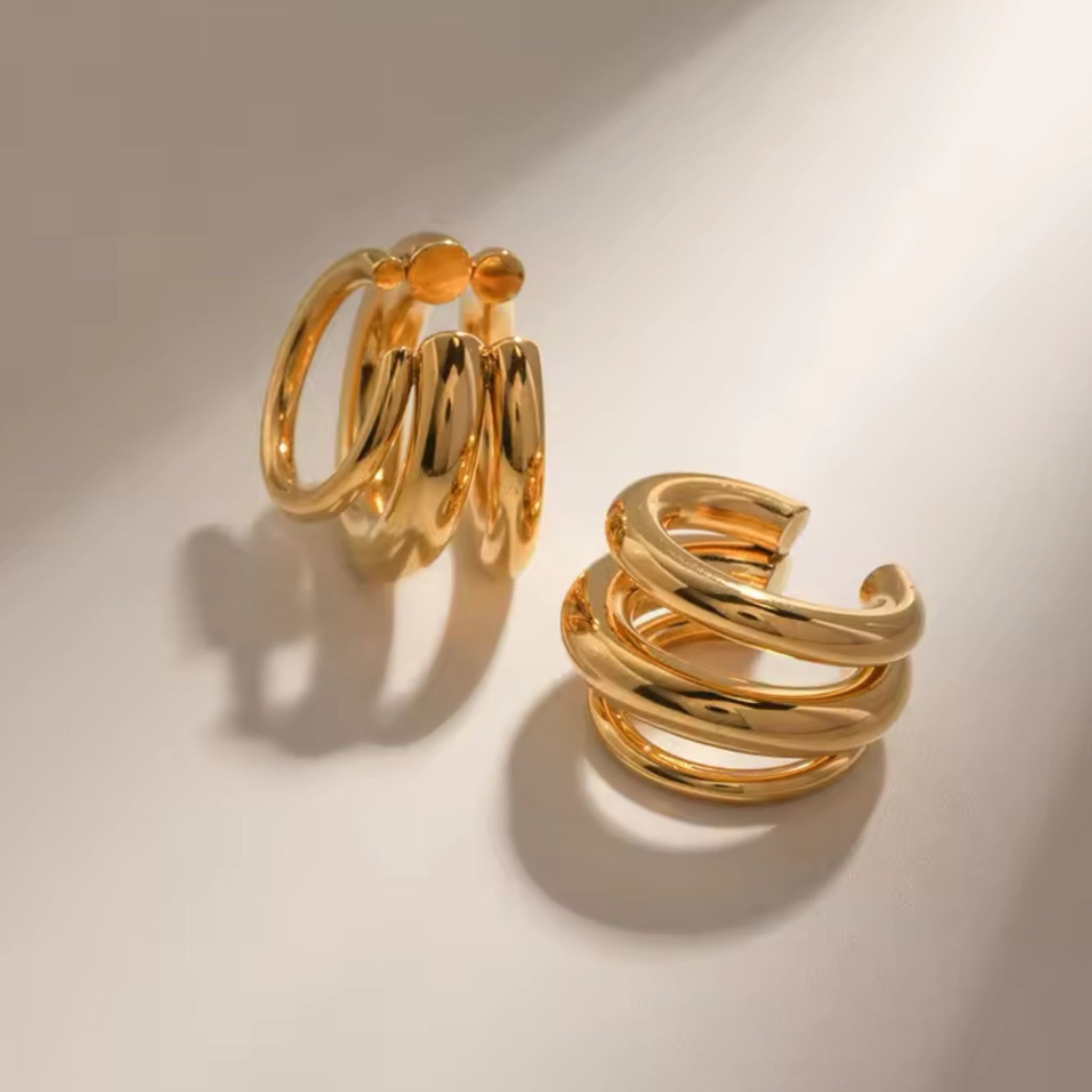 Pair of gold hoop earrings on a light background