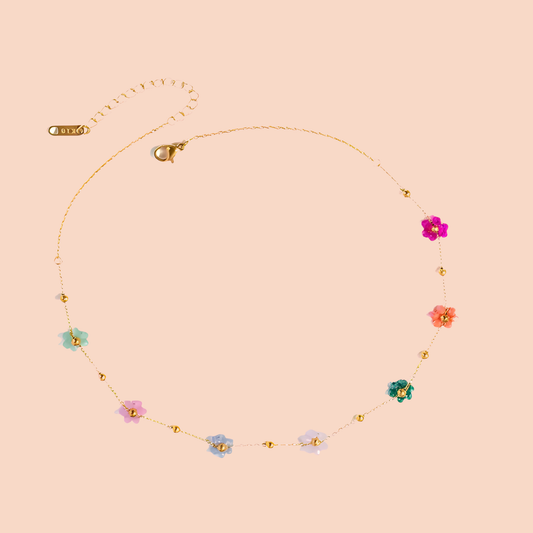 Necklace with colorful floral pendants on a beige background