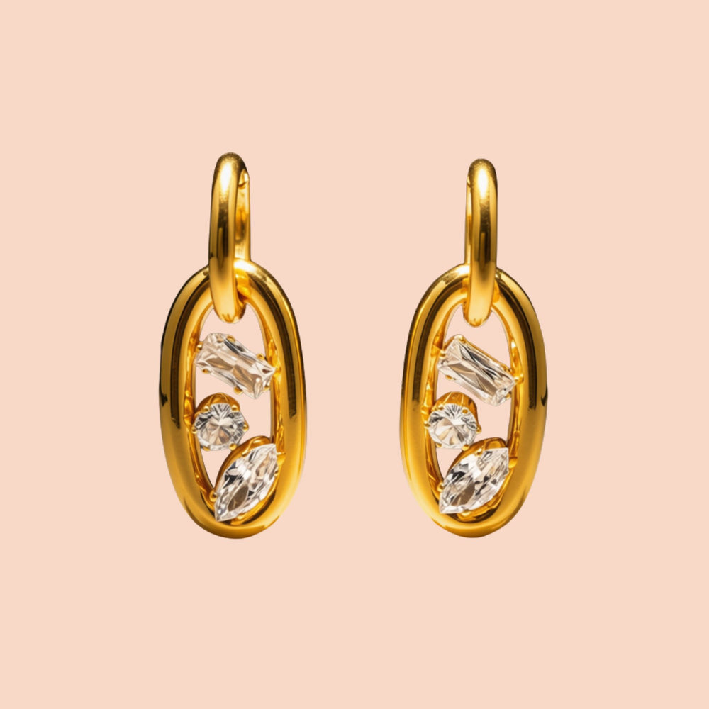 Gold hoop earrings with embedded diamonds on a beige background
