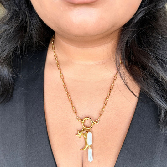 Gold necklace with a moon and star pendant worn by a person