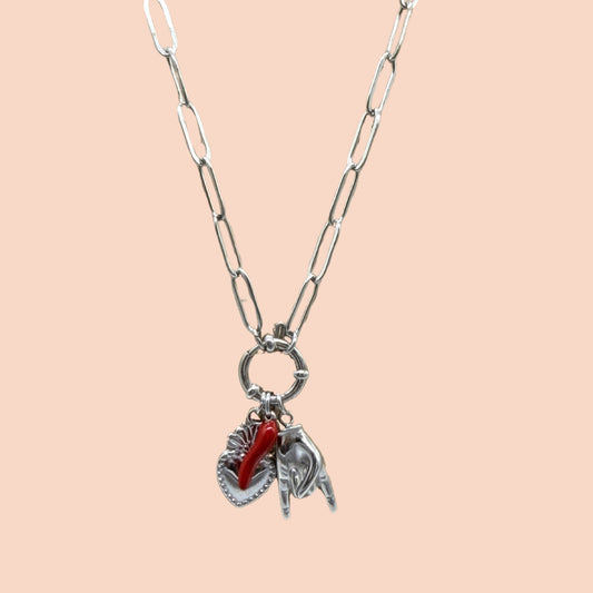 Necklace with heart and horse charm on a beige background